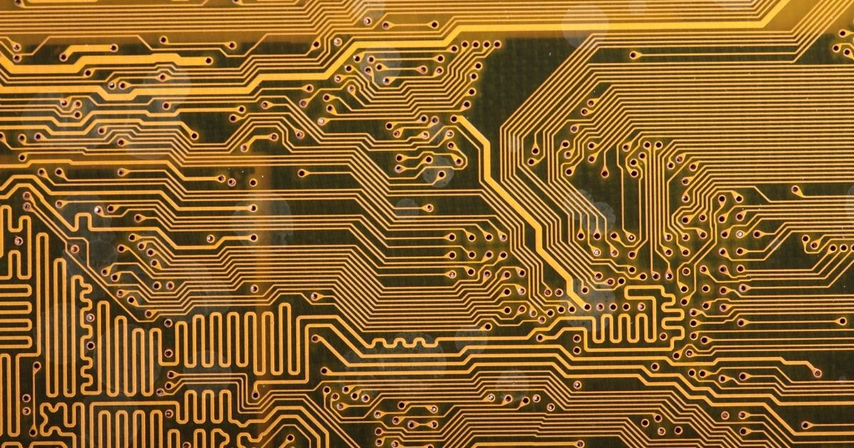 Close-up of a printed circuit board in orange tones
